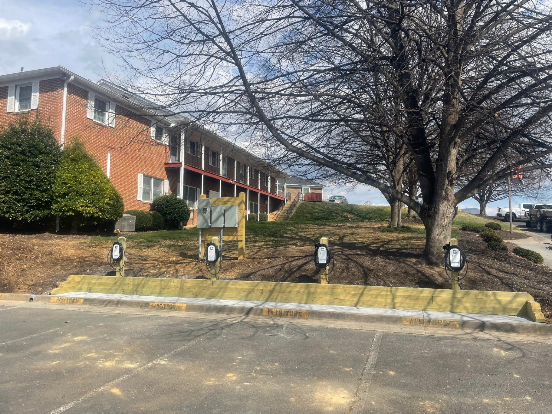 Bank of commercial EV charging stations installed at a parking lot