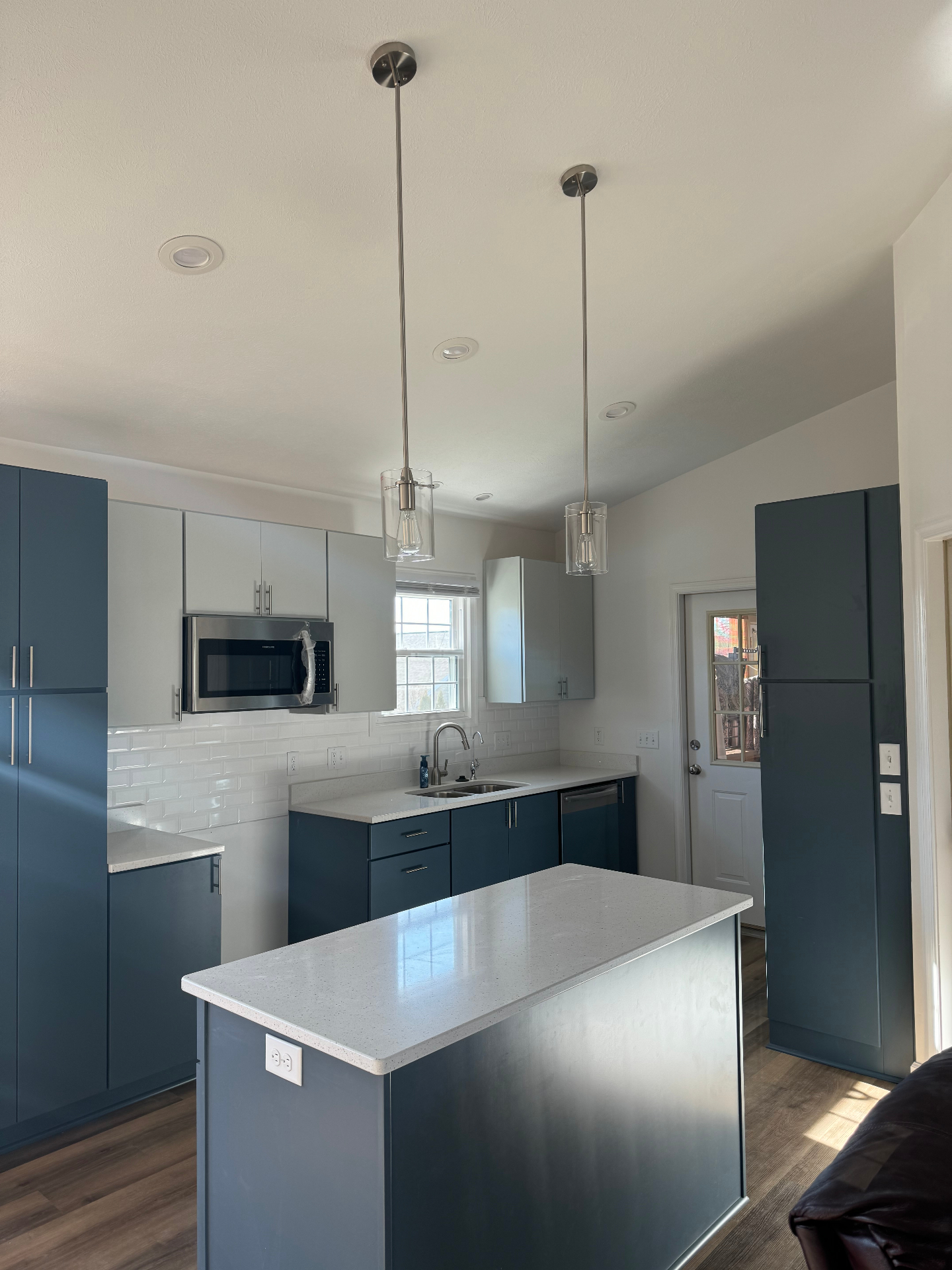 Modern kitchen with pendant lighting and recessed cans installed by Brown Dog Electric